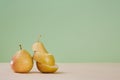 Whole pear and divided on slices. Healthy nutrition. Summer mellow fruit. Diet. Green background. Copy space for text