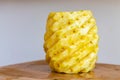 Whole peeled pineapple on a wooden cutting board Royalty Free Stock Photo