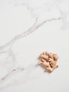 whole piece of fresh ginger root isolated on marble countertop. Royalty Free Stock Photo