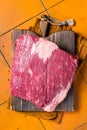 Whole piece of raw Beef Brisket meat. Orange background. Top view Royalty Free Stock Photo