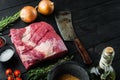 A whole piece of raw Beef Brisket,with ingredients for smoking  making  barbecue, pastrami, cure, on black wooden table background Royalty Free Stock Photo