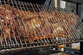 Whole pig roasted on a big grill. Kind of Cheverme, whole animal roasted on a rotating grill. A huge barbecue for a whole swine. O Royalty Free Stock Photo