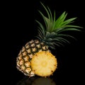 Whole pineapple and cut in half isolated on black background. Royalty Free Stock Photo