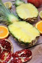 Whole pineapple cut in half, two pieces of pineapple halves, pineapple fruit on wooden background, yellow fruit Royalty Free Stock Photo