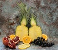 Whole pineapple cut in half, two pieces of pineapple halves, vertically cut pineapple, standing pineapple on a marbled background Royalty Free Stock Photo