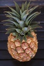 Whole pineapple fruit positioned on a wooden table Royalty Free Stock Photo