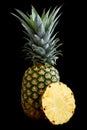 Whole pineapple isolated standing on black. Royalty Free Stock Photo