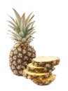 Whole pineapple with stack of slices isolated over white background Royalty Free Stock Photo