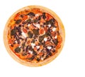 Whole pizza with cherry tomatoes, spinach, mozzarella, feta, kalamata olive and mushrooms on a round wooden platter isolated Royalty Free Stock Photo