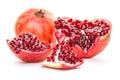 A whole pomegranate disassembled into parts isolated on white background. Healthy red food, diet and organic fair trade concept