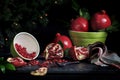 Whole Pomegranates and Seeds in Bowl