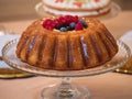 Whole raspberry blueberry pudding cake on cake stand Royalty Free Stock Photo