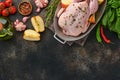Whole raw chicken with ingredients for making rose pepper, lemon, thyme, garlic, cherry tomato, sorrel, apples, salt in the Royalty Free Stock Photo
