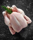 Whole raw Free range chicken in rustic background with rosemary leaf. ready to cook Royalty Free Stock Photo