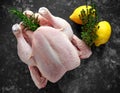 Whole raw Free range chicken in rustic background with rosemary leaf, thyme, lemon. ready to cook Royalty Free Stock Photo