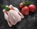 Whole raw Free range chicken in rustic background with rosemary leaf, thyme, red potatoes. ready to cook. Royalty Free Stock Photo