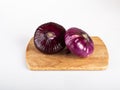 A whole red flat onion on a cutting Board, isolated on a white background