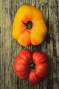 Whole red and yellow heirloom tomatoes on rustic wood tabletop Royalty Free Stock Photo