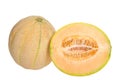 Whole ripe cantaloupe next to half cantaloupe cute lengthwise, showing seeds and connective fibers Royalty Free Stock Photo