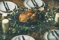 Whole roasted chicken for Christmas, plates and candles Royalty Free Stock Photo