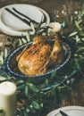 Whole roasted chicken decorated with olive tree branch Royalty Free Stock Photo