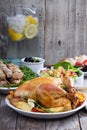 Whole roasted chicken on dinner table Royalty Free Stock Photo