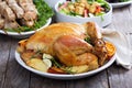 Whole roasted chicken on dinner table Royalty Free Stock Photo