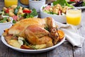 Whole roasted chicken on dinner table Royalty Free Stock Photo