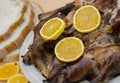 Whole roasted chicken or duck on white plate  decorated with fresh oranges and bread. Selective focus Royalty Free Stock Photo