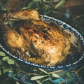 Whole roasted chicken with garlic over wooden background, square crop Royalty Free Stock Photo