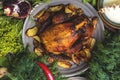 Whole roasted chicken garnished withspices, green salad and baked potatoes on dinner table. Royalty Free Stock Photo