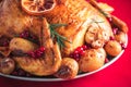 Whole roasted chicken with oranges, cranberries, spices and herbs. Copy space. Friends or family dinner. Festive Christmas table. Royalty Free Stock Photo