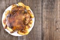 Whole roasted chicken with potatoes on rustic wooden table. Sele Royalty Free Stock Photo