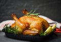 Whole roasted chicken rosemary and tomato lemon on wooden cutting board - Baked chicken grilled barbecue delicious food on dining Royalty Free Stock Photo