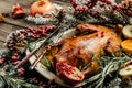 Whole roasted duck with oranges, berries and rosemary. Christmas decorations. Close up Royalty Free Stock Photo