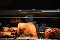 Golden roasted cooked whole turkey with gammon beef and lamb joints in the background Royalty Free Stock Photo