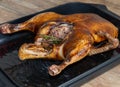 Whole roasted or slowly baked duck in roasting pan