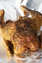 Whole roat chicken, covered in rosemary, on aluminium kitchen foil. Sunday roast concept Royalty Free Stock Photo