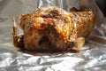 Whole roat chicken, covered in rosemary, on aluminium kitchen foil. Royalty Free Stock Photo