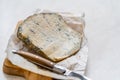 Whole Roquefort French Blue Cheese with Knife on Wooden Board