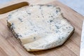 Whole Roquefort French Blue Cheese with Knife on Wooden Board