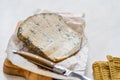 Whole Roquefort French Blue Cheese with Knife on Wooden Board