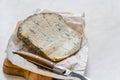 Whole Roquefort French Blue Cheese with Knife on Wooden Board