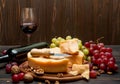 Whole round Head parmesan cheese, wine and grapes Royalty Free Stock Photo