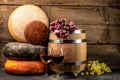 Whole round Head of parmesan or parmigiano hard cheese and wine on a wooden background. farmer market. place for text Royalty Free Stock Photo