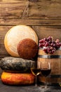 Whole round Head of parmesan or parmigiano hard cheese and wine on a wooden background. farmer market. place for text Royalty Free Stock Photo