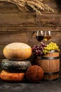 Whole round Head of parmesan or parmigiano hard cheese and wine on a wooden background. farmer market. place for text Royalty Free Stock Photo