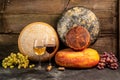 Whole round Head of parmesan or parmigiano hard cheese and wine on a wooden background. farmer market. place for text Royalty Free Stock Photo