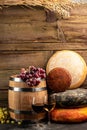 Whole round Head of parmesan or parmigiano hard cheese and wine on a wooden background. farmer market. place for text Royalty Free Stock Photo