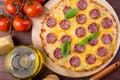 Whole salami pizza on a wooden cuttig board Royalty Free Stock Photo